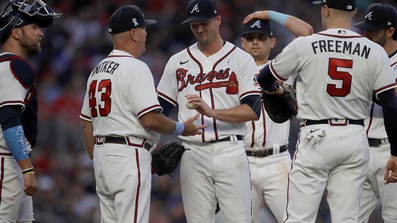 Braves pitcher Drew Smyly (center) hands the ball to manager Brian Snitker (43) in the sixth inning of the second game of a doubleheader against the St. Louis Cardinals, Sunday, June 20, 2021, at Truist Park in Atlanta. (Ben Margot/AP)