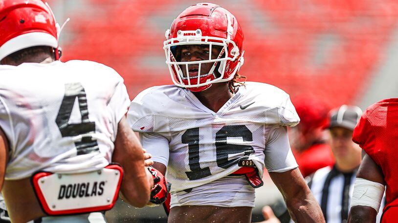 Georgia safety Lewis  Cine (16), congratulates outside linebacker Nolan Smith after a play during the Bulldogs’ scrimmage on Dooley Field at Sanford Stadium this past Saturday (Photo by Tony Walsh/UGA Athletics)