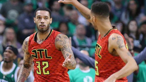 Mike Scott of the Hawks (left) gets five from Thabo Sefolosha during Game 6 of an NBA basketball first-round playoff series at TD Garden on Thursday, April 28, 2016, in Boston. Curtis Compton / ccompton@ajc.com