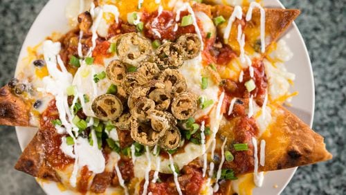 Huevos Rancheros over fried tortilla shells, loaded with chorizo, black beans, onions, peppers, cheese, salsa, sour cream, fried jalapeños and green onions. Photo credit: Mia Yakel.