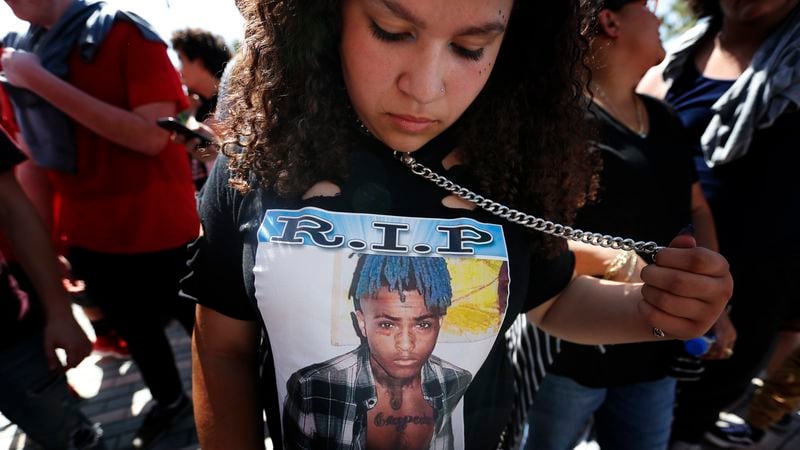 Fan Ayanna Gonzalez, 13, of New Jersey, wears a T-shirt in honor of the late rapper XXXTentacion as she waits in line for his memorial on Wednesday, June 27, 2018, in Sunrise, Fla. The rapper was gunned down in a luxury sports car last week.