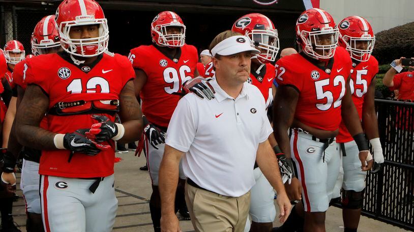 Georgia head coach Kirby Smart leads his team to the field for warmups before a NCAA college football game in Athens against Mississippi State. BOB ANDRES /BANDRES@AJC.COM