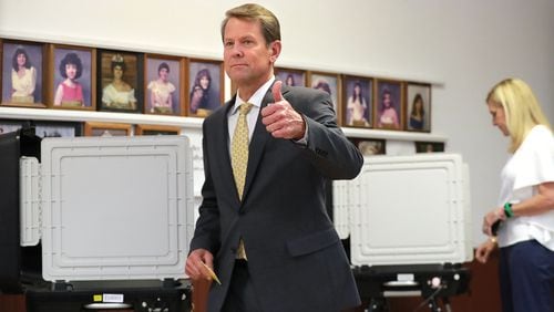 Secretary of State Brian Kemp signals confidence after casting his ballot Tuesday at the Winterville Train Depot in the Republican runoff for governor. Kemp, who won by a comfortable margin, will face Democrat Stacey Abrams in November’s general election. Curtis Compton/ccompton@ajc.com