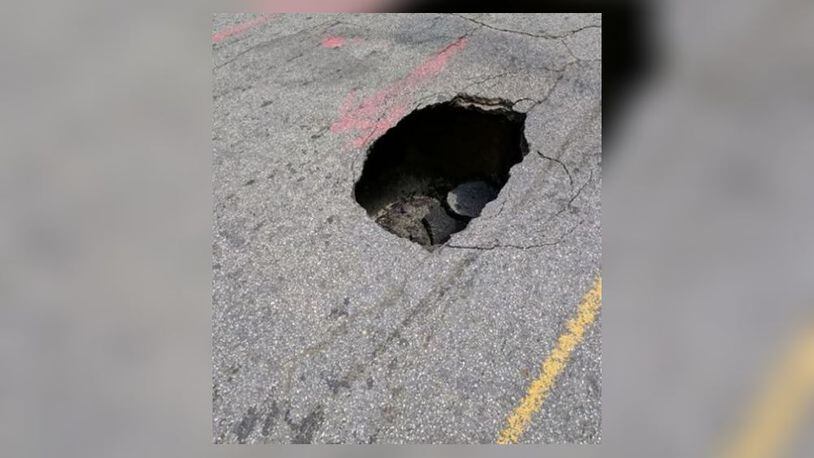 A sinkhole closed a portion of 5th Street in Midtown. (Credit: Facebook/Atlanta Police Department)