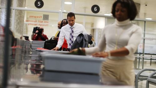 Nov. 23, 2015 - Atlanta - Airport employees make their way through security in a timed test to show how possession of prohibited items delays the line. TSA personnel demonstrated how they respond to prohibited items at security checkpoints in a session for the press using airport employees playing the part of passengers. The Transportation Security Administration is advising travelers to keep prohibited items out of their bags to keep security lines moving. At Hartsfield-Jackson Atlanta International Airport, more than 130 people have been caught with guns at airport security checkpoints so far this year. Whenever a gun, explosive or other dangerous weapons are caught at checkpoints, TSA officers halt security screening in the lane and call Atlanta police to respond to the checkpoint. BOB ANDRES / BANDRES@AJC.COM