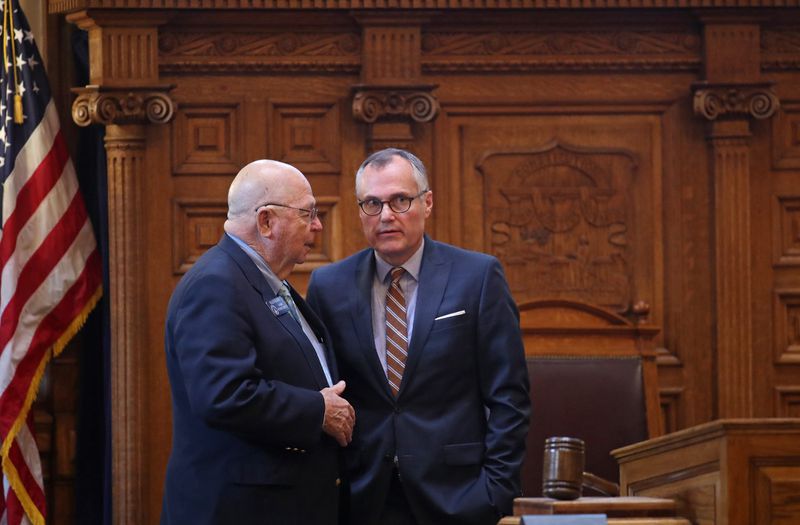 Lt. Gov. Casey Cagle, center, talks with Sen. Ellis Black, R - Valdosta, in the Senate Chamber during Legislative on Feb. 26, 2018, at the Georgia State Capitol. Cagle was successful in his vow to “kill” a tax break for airlines, including Atlanta-based Delta, after Delta upset many Republican leaders by ending a discount offer for National Rifle Association members in the wake of a deadly Florida school shooting. PHOTO / JASON GETZ