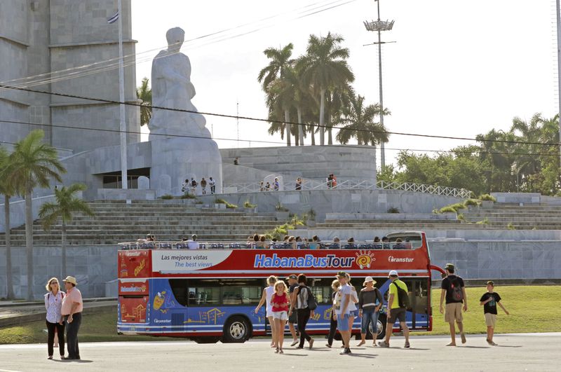 Tourists visit the Plaza de la Revolucion in Havana.