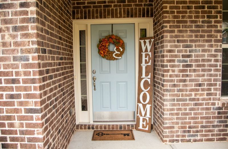 A fall-themed door ornament can welcome guests. Reann Huber/FOR THE AJC