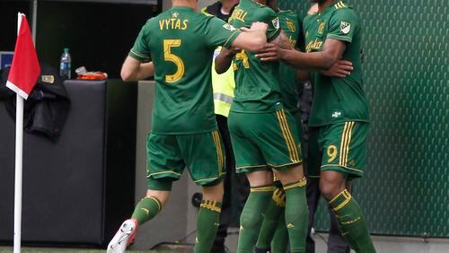 Portland Timbers players celebrate Liam Ridgewell’s (24) goal against Atlanta United FC in an MLS soccer match in Portland, Ore., Sunday, May 14, 2017. (Sean Meagher/The Oregonian via AP)