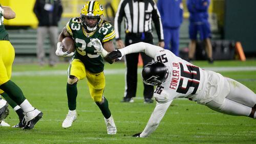 Packers RB Aaron Jones runs past Dante Fowler of the Falcons during the second half of Monday's game.