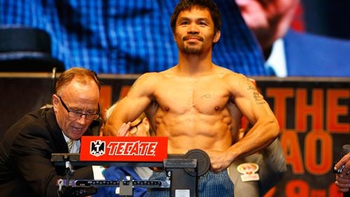 LAS VEGAS, NV - MAY 01: Manny Pacquiao poses on the scale during his official weigh-in on May 1, 2015 at MGM Grand Garden Arena in Las Vegas, Nevada. Pacquiao will face Floyd Mayweather Jr. in a welterweight unification bout on May 2, 2015 in Las Vegas. (Photo by Al Bello/Getty Images)