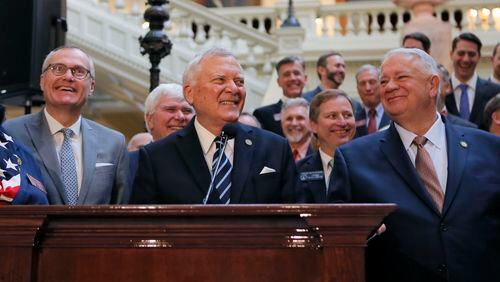 Gov. Nathan Deal, flanked by Lt. Gov. Casey Cagle (left) and House Speaker David Ralston, announced Tuesday that a compromise had been reached on a plan for dealing with the massive state windfall created by the federal tax law. The Georgia House approved the plan, House Bill 918, on Thursday. It calls for a reduction in the state income tax rate and an increase in the standard deduction. BOB ANDRES /BANDRES@AJC.COM