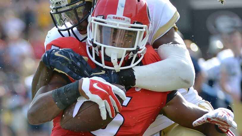 November 28, 2015 Atlanta - Georgia Bulldogs wide receiver Terry Godwin (5) gets tackled from behind by Georgia Tech Yellow Jackets defensive back D.J. White (28) in the second half at Bobby Dodd Stadium on Saturday, November 28, 2015. Georgia Bulldogs won 13 - 7 over the Georgia Tech Yellow Jackets. HYOSUB SHIN / HSHIN@AJC.COM