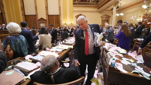 March 29, 2018 - Atlanta, Ga: Sen. Lee Anderson, R-Grovetown, center, leaves his desk as he greets Sen. David Lucas, D-Macon, after Sine Die was proclaimed shortly after midnight during Legislative Day 40 in the Senate Chamber at the Georgia State Capitol Thursday, March 29, 2018, in Atlanta. PHOTO / JASON GETZ