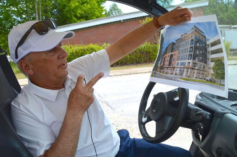 Lilburn Mayor Johnny Crist talks about apartments slated to be built as Railroad Avenue during a tour of the city. (Photo Courtesy of Curt Yeomans/Gwinnett Daily Post)