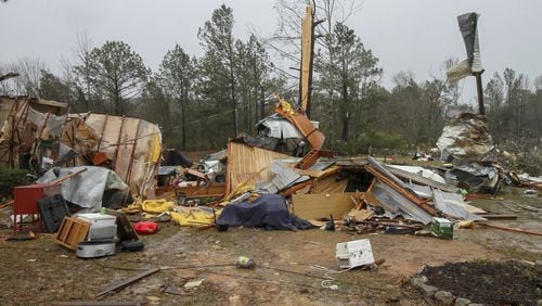 Parts of mobile homes and other property lay strewn throughout a neighborhood Sunday, Jan. 22, 2017, on Green Loop Road in Lauderdale, Miss., after a tornado passed through the area late Saturday. (Paula Merritt/The Meridian Star via AP)