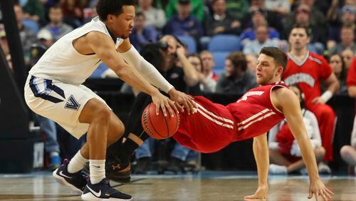 Villanova guard Jalen Brunson (1) is defended by Wisconsin guard Zak Showalter, right, during the first half of a second-round men's college basketball game in the NCAA Tournament, Saturday, March 18, 2017, in Buffalo, N.Y. (AP Photo/Bill Wippert)
