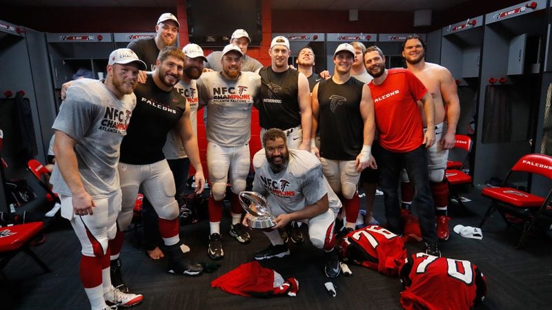  The Atlanta Falcons celebrate in the locker room with the George Halas Trophy after defeating the Green Bay Packers in the NFC Championship Game at the Georgia Dome on January 22, 2017 in Atlanta. The Falcons defeated the Packers 44-21. (Kevin C. Cox/Getty Images)