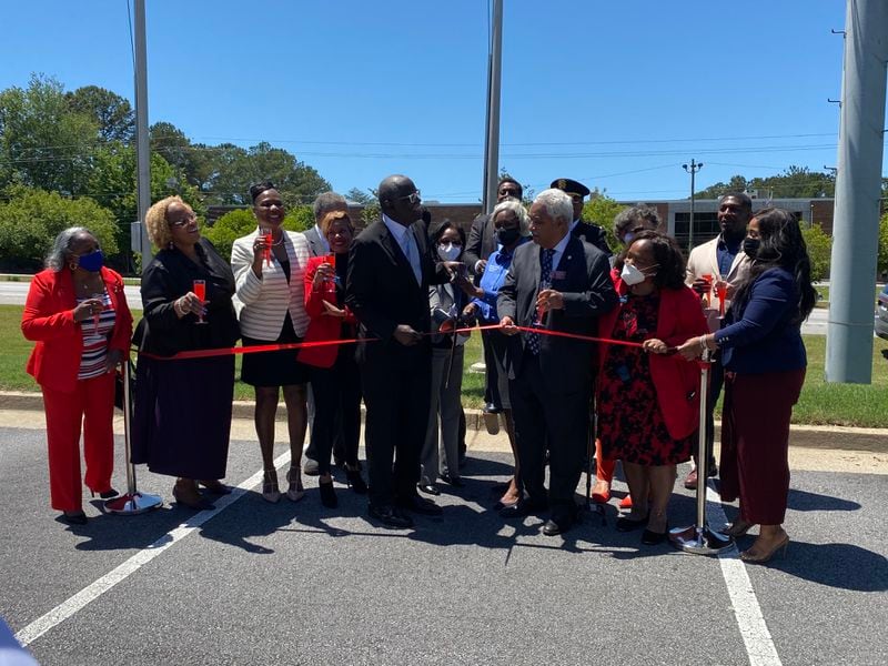 South Fulton Mayor Bill Edwards, center with ceremonial scissors, celebrates the city's annexation of most of Fulton Industrial Boulevard on Thursday, May 13, 2021. (Ben Brasch)