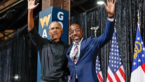 Former President Barack Obama and Sen. Raphael Warnock wave to supporters during a campaign rally at Pullman Yards in Atlanta on Thursday, December 1, 2022. (Natrice Miller/natrice.miller@ajc.com)  