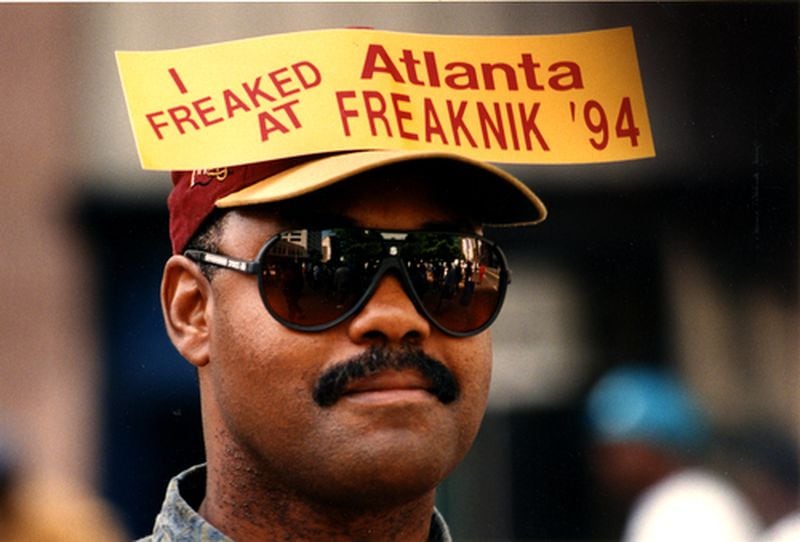 1994: Wearing a sticker on his hat, William Simms stands on Peachtree Street watching the Freaknik crowds walk by. AJC file 1994