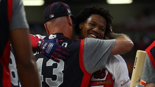 Braves outfielder Ronald Acuna gets a hug from manager Brian Snitker as he advanced Monday, July 8, 2019, in the Home Run Derby at Progressive Field in Cleveland.