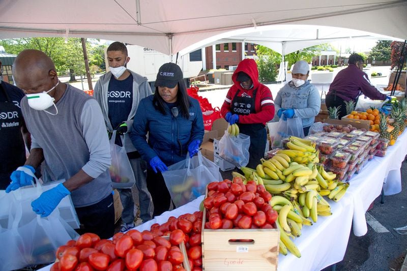Volunteers assemble food bags before the start of the City of College Park's first pop-up grocery store on Saturday, April 18, 2020. STEVE SCHAEFER / SPECIAL TO THE AJC