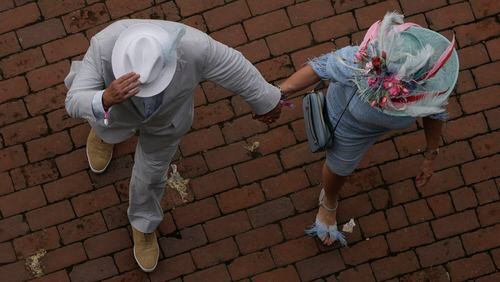 Race fans arrives at Churchill Downs before the 150th running of the Kentucky Derby horse race Saturday, May 4, 2024, in Louisville, Ky. (AP Photo/Charlie Riedel)