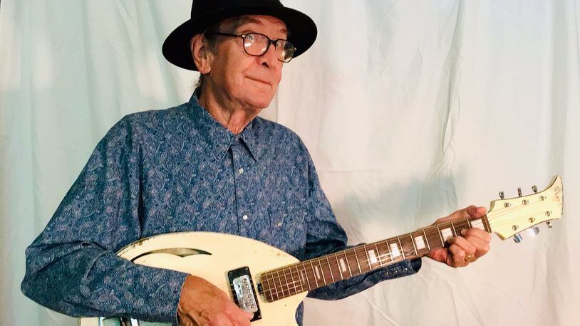 Bob Hay, founder of Athens band Squalls is pictured holding his unique Apollo Guitar - in a photograph taken August 3, 2022. 
(Courtesy of Vanessa Briscoe Hay.)