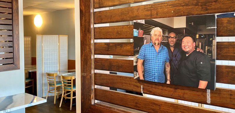 A 2019 appearance on Guy Fieri’s “Diners, Drive-Ins and Dives” put Smyrna’s Yakitori Jinbei on the map. Owner Jae Choi is shown on the right with Fieri (left) and chef G. Garvin. Wendell Brock/For The AJC
