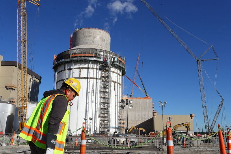 Waynesboro: One of thousands of construction workers passes by the exterior work on Unit 4 (the second new reactor area) at Georgia Power's Plant Vogtle expansion on Tuesday, Dec 14, 2021, south of Augusta. Curtis Compton / Curtis.Compton@ajc.com
