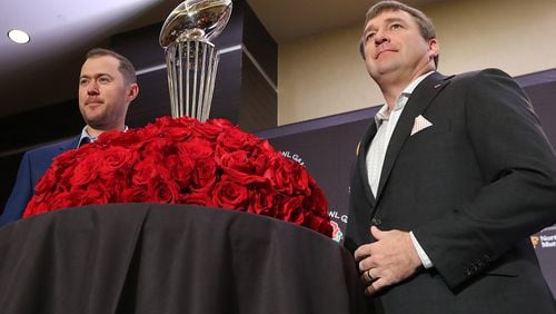 Georgia’s Kirby Smart and Oklahoma’s Lincoln Riley stand with the Rose Bowl trophy at the conclusion of the head coaches’ final pre-game press conference on Sunday in Los Angeles.