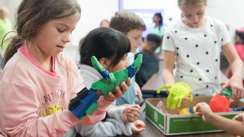 A Blackwell Elementary School student tries on the robotic arm.