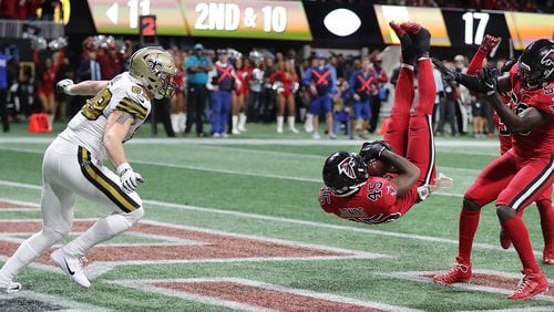 Atlanta Falcons linebacker Deion Jones intercepts New Orleans Saints quarterback Drew Brees' pass intended for tight end Josh Hill (left) in the end zone to hold on to a 20-17 victory on Thursday, Dec. 7, 2017, in Atlanta, Ga. (Curtis Compton/Atlanta Journal-Constitution/TNS)