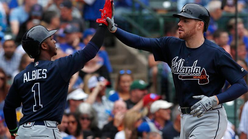 Freddie Freeman, right, celebrates his home run against the Cubs with teammate Ozzie Albies during the third inning of a baseball game Saturday, Sept. 2, 2017, in Chicago. (AP Photo/Jim Young)