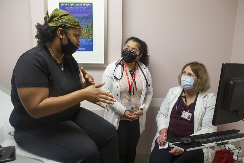 Lashika Steele (left), a primary care patient, is seen at Mercy Care clinic by Claudina Rubio (center) and Pamela Spearman (right), nurse practitioners, on Thursday, December 8, 2022, in Atlanta. Mercy Care is a charity clinic that will help fill the void in primary care left by the closing of Atlanta Medical Center. CHRISTINA MATACOTTA FOR THE ATLANTA JOURNAL-CONSTITUTION.