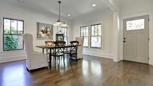 White shiplap, industrial lighting and warm wood floors create the perfect ambiance in this Ormewood Park renovation.