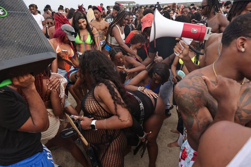 A crowd of partiers gathers on the beach for Orange Crush in Tybee Island on Saturday, April 20, 2024. (Natrice Miller/ AJC)