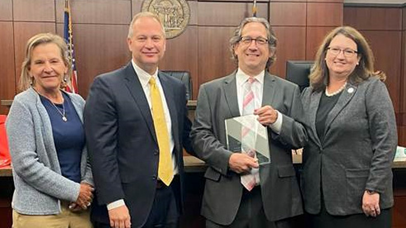 Michael Syrop (second from right) holds an award for his service as a public defender in Cobb County. Others (from left) include Judge Ann Harris, Chief Judge Rob Leonard and Judge Kimberly Childs.