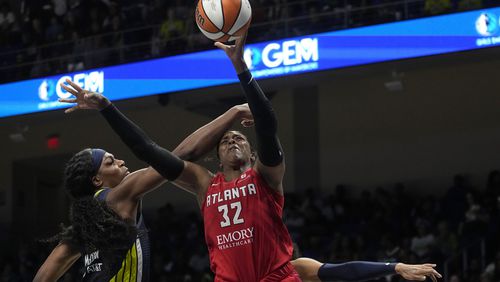 Atlanta Dream forward Cheyenne Parker (32) takes a shot as Dallas Wings center Teaira McCowan, left, defends in Game 2 of a first-round WNBA basketball playoff series, Tuesday, Sept. 19, 2023, in Arlington, Texas. Dallas won 101-74 and took the series 2-0.  (AP Photo/Tony Gutierrez)