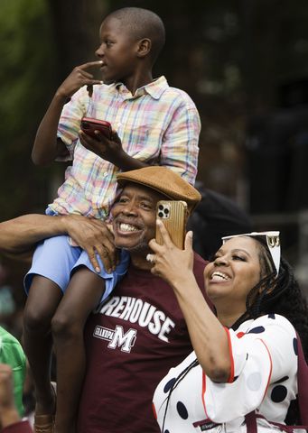 Rober Sherman holds his grandson while cheering for their graduate during the Morehouse College commencement ceremony on Sunday, May 21, 2023, on Century Campus in Atlanta. The graduation marked Morehouse College's 139th commencement program. CHRISTINA MATACOTTA FOR THE ATLANTA JOURNAL-CONSTITUTION