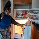 09/24/2021 — Atlanta, Georgia — Tranisha Wilcox looks inside her broken refrigerator at her residence at the Pavilion Place Apartments in Atlanta’s Hammond Park community, Friday, September 24, 2021. After having issues with her first refrigerator, Tranisha requested a new one. The replacement is also broken. Tranisha has to visit the store, almost on a daily basis, because the bottom half of the refrigerator does not keep food cold. (Alyssa Pointer/Atlanta Journal Constitution)