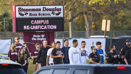 Students and their parents arrive at Marjory Stoneman Douglas High School in Parkland, Fla. (Lannis Waters /The Palm Beach Post)