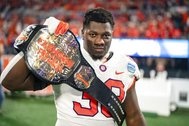 Clemson defensive tackle Ruke Orhorhoro (33) reacts after defeating North Carolina during the Atlantic Coast Conference championship NCAA college football game on Saturday, Dec. 3, 2022, in Charlotte, N.C. (AP Photo/Jacob Kupferman)