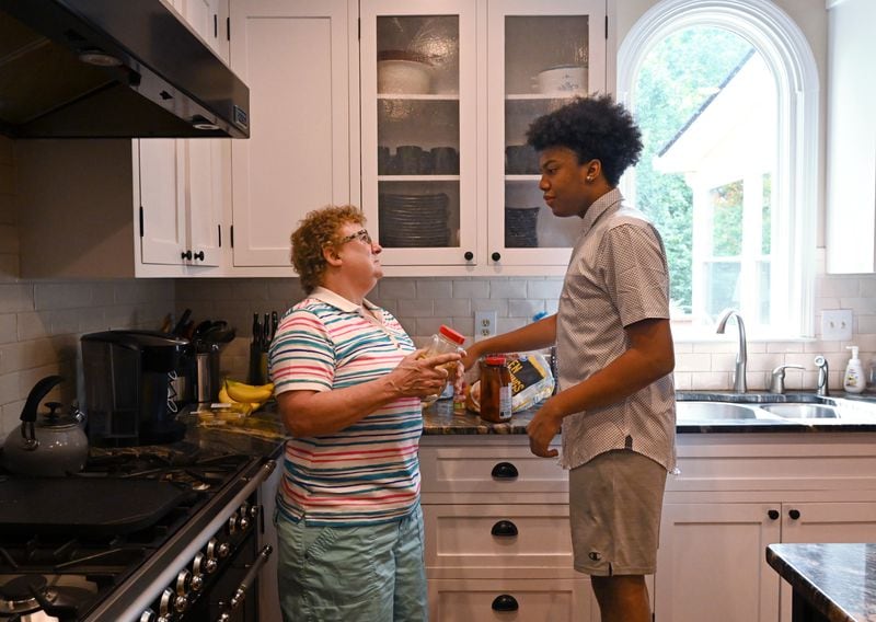 Judy Veschi talks with one of her adopted children, Aaron, 14, at their home in Alpharetta on Wednesday, September 9, 2020. (Hyosub Shin / Hyosub.Shin@ajc.com)