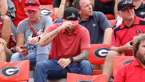The portrait of the local fan: Three days after the Braves were ousted from the 2019 National League Division Series, this fellow in his tomahawk cap suffers a Georgia football loss to South Carolina. (Curtis Compton/ccompton@ajc.com)