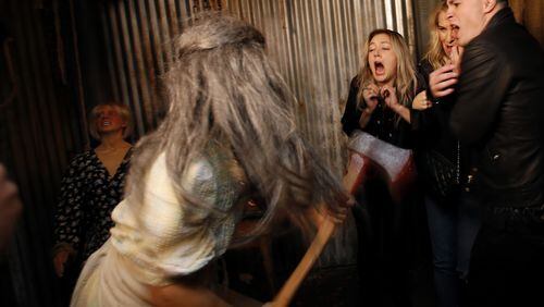 Actors Billie Lourd, left, Leslie Grossman, middle, and Colton Haynes, right, member’s of the cast of the new season of FX’s “American Horror Story” get spooked while traversing the American Horror Story: Roanoke attraction at Universal Studios. Contributed by Francine Orr/Los Angeles Times/TNS