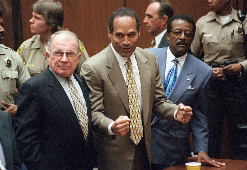 FILE - In this Oct. 3, 1995, file photo, O.J. Simpson reacts as he is found not guilty in the death of his ex-wife Nicole Brown Simpson and her friend Ron Goldman in Los Angeles. Defense attorneys F. Lee Bailey, left, and Johnnie L. Cochran Jr. stand with him. Simpson, the decorated football superstar and Hollywood actor who was acquitted of charges he killed his former wife and her friend but later found liable in a separate civil trial, has died. He was 76. (Myung J. Chun/Los Angeles Daily News via AP, Pool, File)