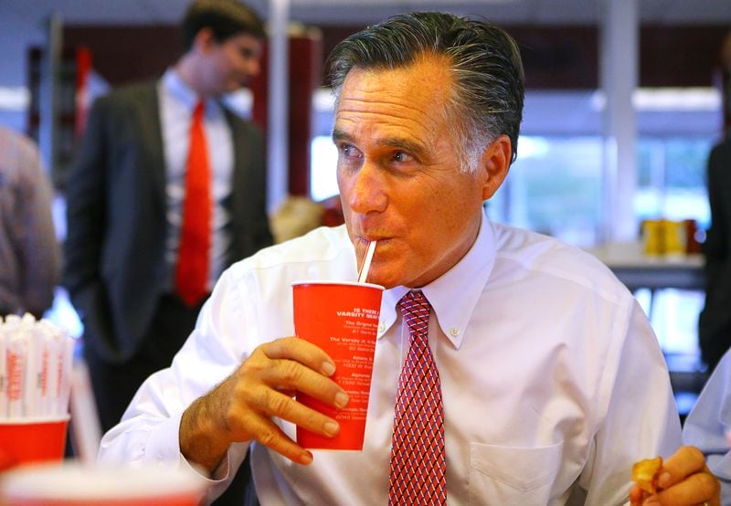100114 ATLANTA: Former presidential hopeful Mitt Romney enjoys a iconic frosted orange while stumping in Georgia for Attorney General Sam Olens, joining Olens for lunch at The Varsity on Wednesday, Oct. 1, 2014, in Atlanta.       CURTIS COMPTON / CCOMPTON@AJC.COM