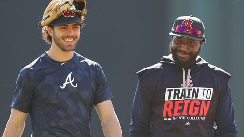 Braves shortstop Dansby Swanson shares a laugh with second baseman Brandon Phillips at a recent spring training practice. Swanson is viewed as one of the present and future stars of the team. (Curtis Compton/ccompton@ajc.com)